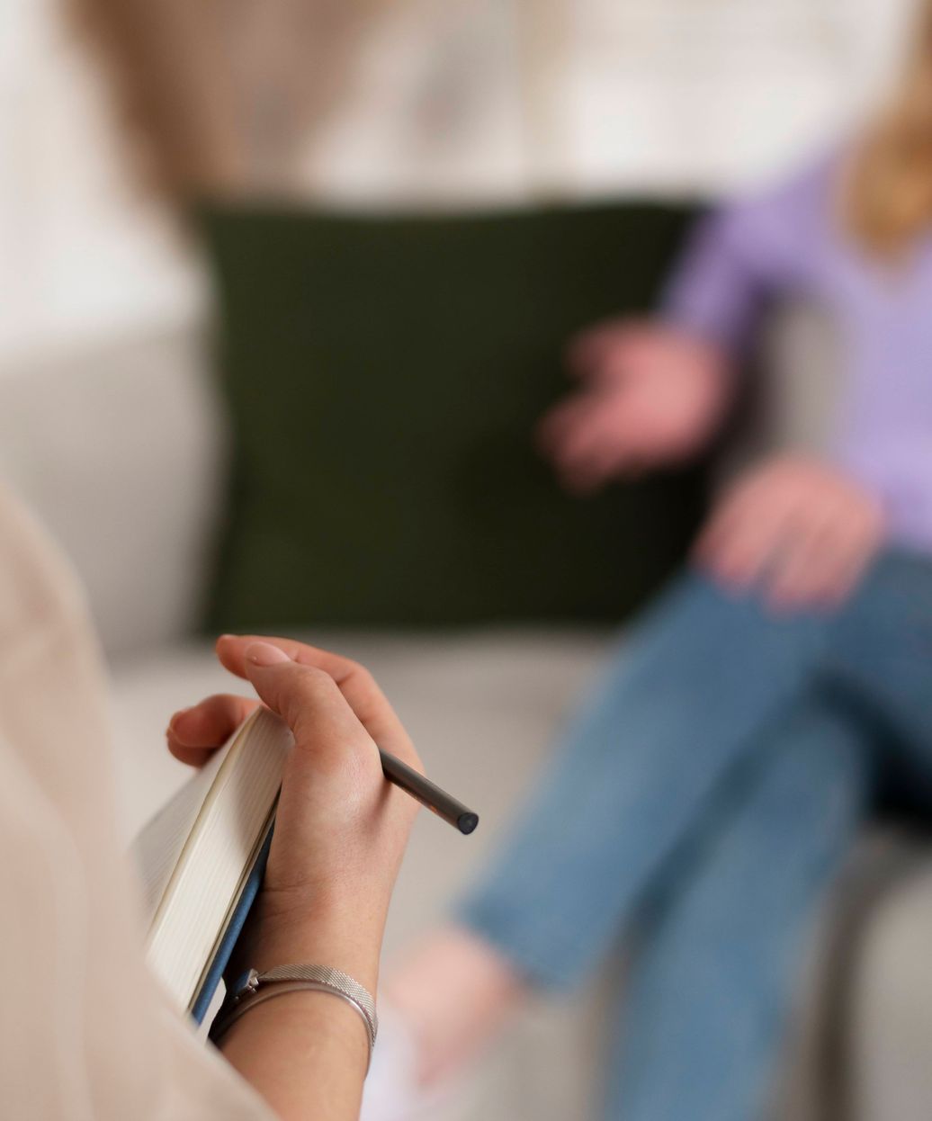 therapist in foreground speaking with a blurred woman in the background